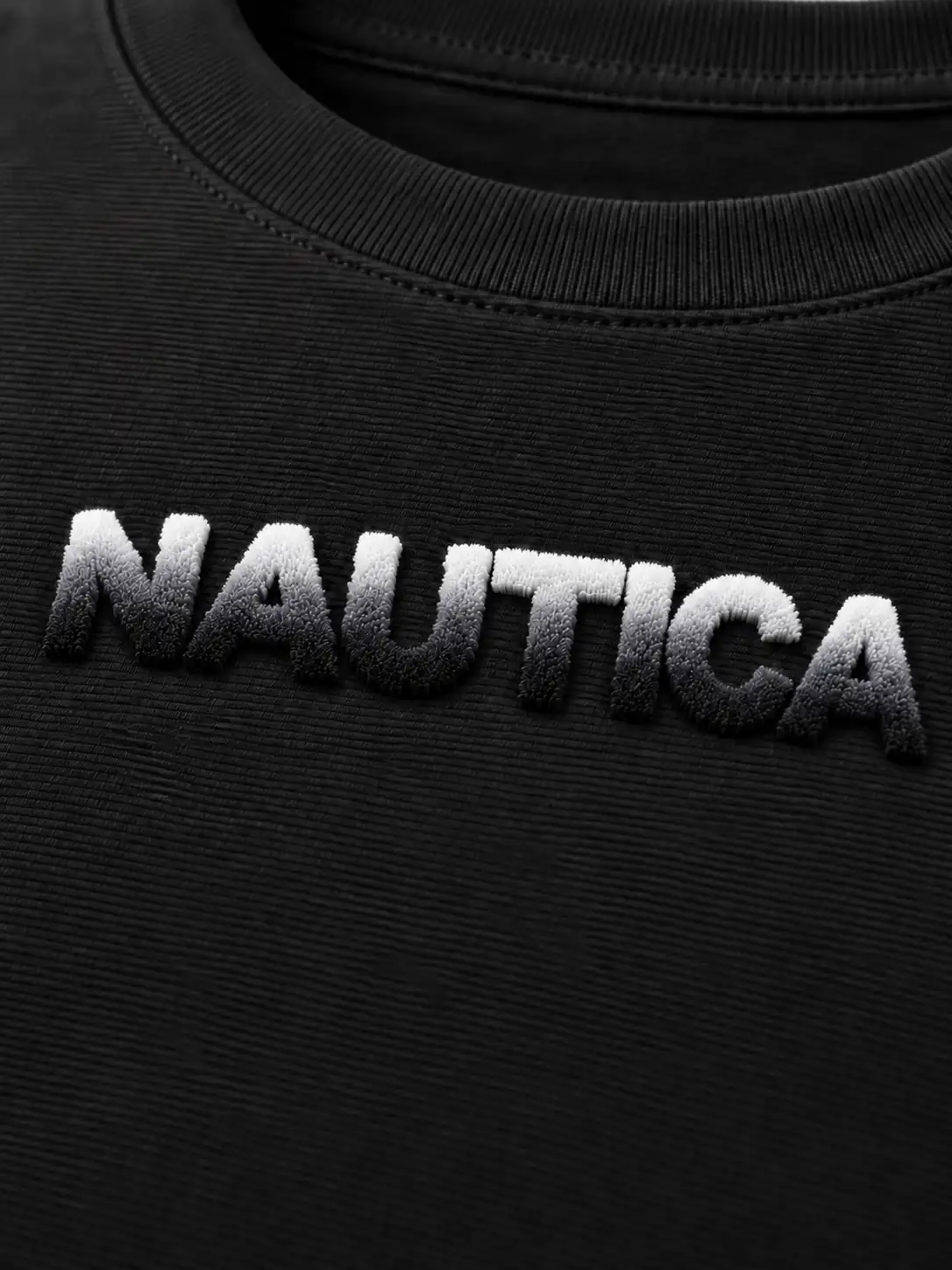 Soft dense toothbrush embroidery with black-and-white ombre raised lettering on fine horizontal Ottoman knit