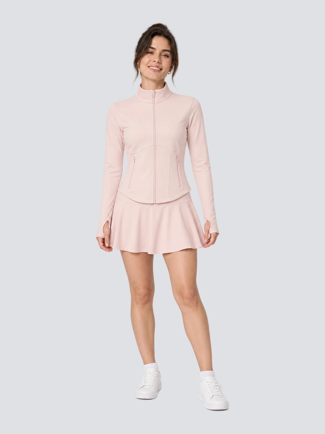 Pale pink women's fitted golf jacket and skort set with built-in shorts