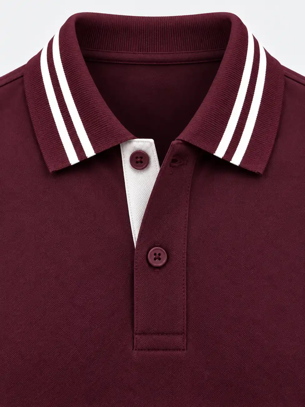 Close-up of a burgundy flat-knit collar with two white knitted stripes and an open two-button placket showing a pale inner strip