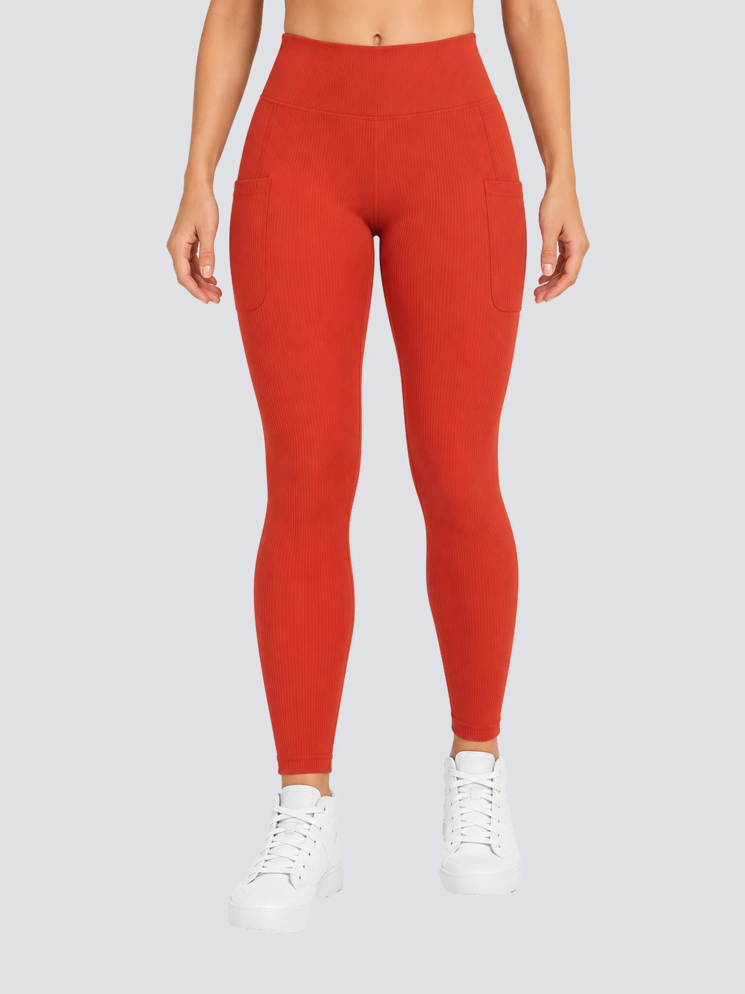 Orange-red high-waist training leggings with side phone pockets